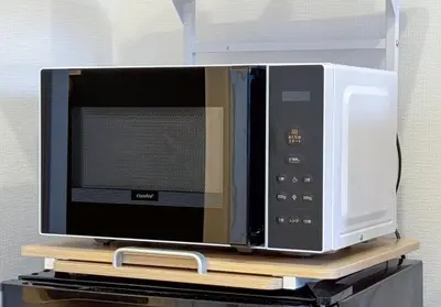 a microwave oven sitting on top of a shelf at -Higashi Shinjuku 1009- in Tokyo