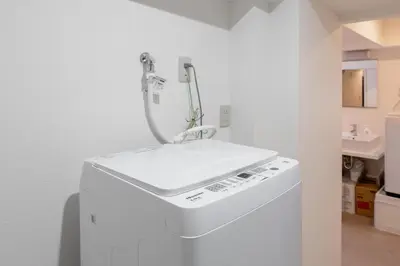 a kitchen with a sink and a washing machine at HIgashi-Shinjuku 1011 in Tokyo