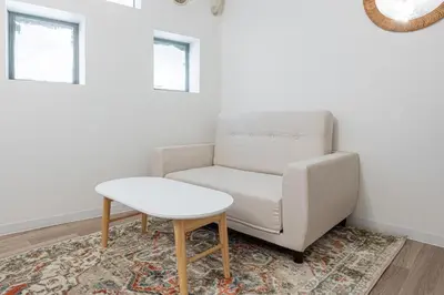 a chair and a table in a room at Higashi-Shinjuku 1012 in Tokyo