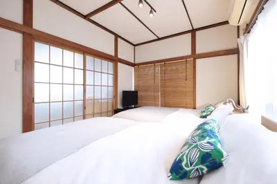 a bedroom with two beds and a window at Yoyogi Flats - Vacation STAY 18018 in Tokyo