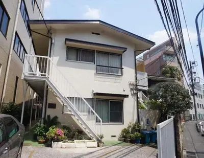 a white house with a staircase in front of it at Yoyogi Flats - Vacation STAY 18018 in Tokyo