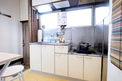 a kitchen with white cabinets and a sink at Yoyogi Flats - Vacation STAY 18018 in Tokyo