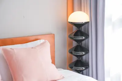 a lamp on a black stand next to a bed at Midland Hotel-\u79cb\u8449\u539f8\u52064\u968e\u5efa\u30664LDK\u8cb8\u5207\u5225\u8358 in Tokyo