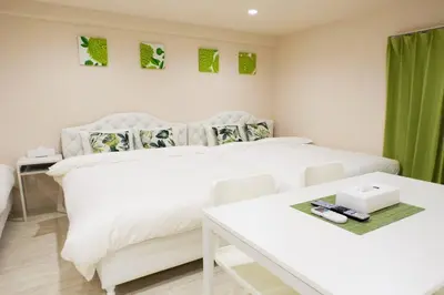 a white bedroom with a white bed and a table at SLEEPLAB THE STAY Casual \u65b0\u5bbf2 in Tokyo