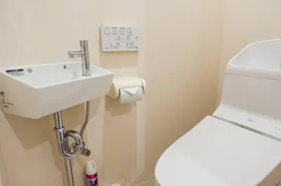 a bathroom with a white sink and a toilet at SLEEPLAB THE STAY Casual \u65b0\u5bbf2 in Tokyo