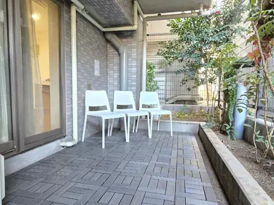 a group of three white chairs sitting on a patio at SLEEPLAB THE STAY Casual \u65b0\u5bbf2 in Tokyo