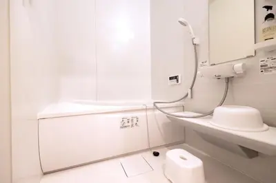a white bathroom with a shower and a toilet at K's Casa西新井 駅徒歩4分 ディズニー車26分 56m2 ハンギングチェア 下町の快い暮らし in Tokyo
