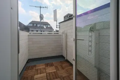 a bathroom with a glass door and a wooden floor at URBAN HOUSE HATAGAYA - Vacation STAY 52809v in Tokyo