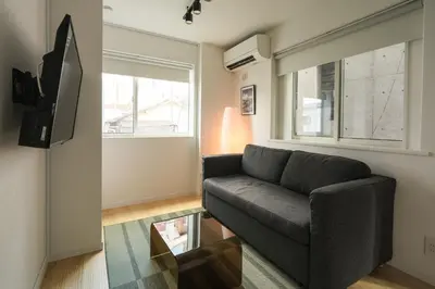 a living room with a couch and a glass table at URBAN HOUSE HATAGAYA - Vacation STAY 52809v in Tokyo