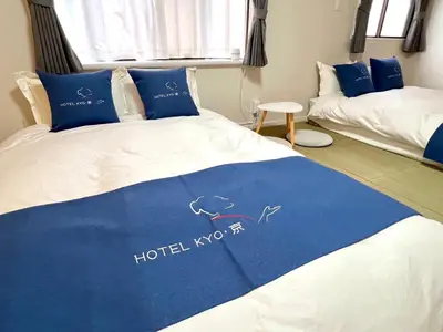 a bedroom with a bed with a blue and white blanket at HOTEL Kyo in Tokyo