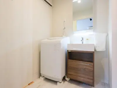 a bathroom with a white refrigerator and a sink at HOTEL Kyo in Tokyo