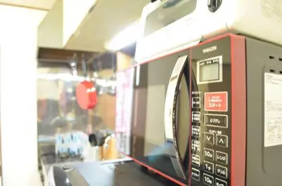 a microwave oven on a shelf in a kitchen at Shibuya South JP House in Tokyo
