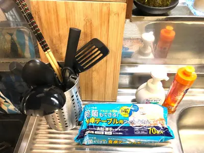 a kitchen sink with utensils and a container of food at Shibuya South JP House in Tokyo