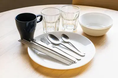 a white plate with silverware on a table at Harebare apartment for max 4ppl 3mins walk from Kiba station 3F in Tokyo