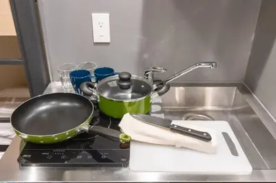 a frying pan on top of a stove in a kitchen at Harebare apartment for max 4ppl 3mins walk from Kiba station 3F in Tokyo