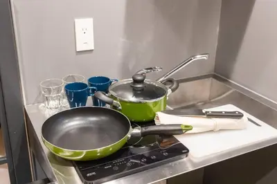 a frying pan on top of a stove in a kitchen at Harebare apartment for max 4ppl 3mins walk from Kiba station 3F in Tokyo