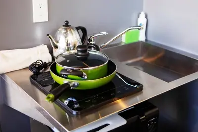 a green pot sitting on top of a stove in a kitchen at Harebare apartment for max 4ppl 3mins walk from Kiba station 3F in Tokyo