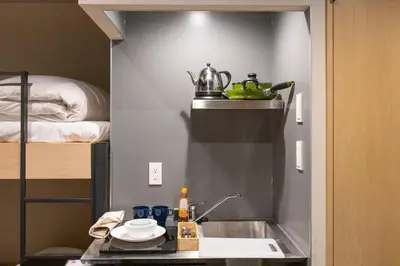 a small kitchen with a sink and a bed at Harebare apartment for max 4ppl 3mins walk from Kiba station 3F in Tokyo