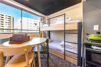 a small room with a table and bunk beds at Harebare apartment for max 4ppl 3mins walk from Kiba station 4F in Tokyo