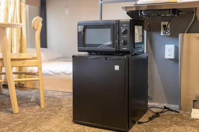 a microwave and a television on top of a refrigerator at Harebare apartment for max 4ppl 3mins walk from Kiba station 4F in Tokyo