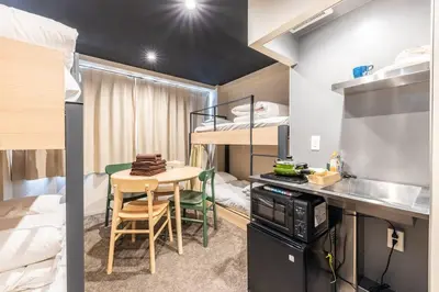 a small room with a table and a bunk bed at Harebare apartment for max 4ppl 3mins walk from Kiba station 4F in Tokyo