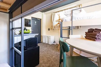 a room with a table and a bunk bed at Harebare apartment for max 4ppl 3mins walk from Kiba station 4F in Tokyo