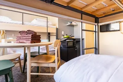 a room with a bed and a table and bunk beds at Harebare apartment for max 4ppl 3mins walk from Kiba station 4F in Tokyo