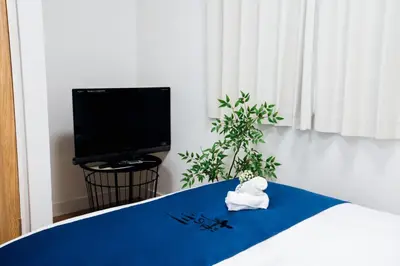 a room with a bed with a towel on it at \u685c\u306e\u5ddd16 \u6c60\u888b\u4e00\u6238\u5efa \u6c60\u888b\u99c5 5\u5206 2-11\u4eba\u4e28Ikebukuro Villa Ikebukuro 5 minutes 2-11 people in Tokyo