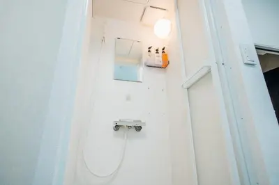 a bathroom with a toilet in a white room at \u685c\u306e\u5ddd16 \u6c60\u888b\u4e00\u6238\u5efa \u6c60\u888b\u99c5 5\u5206 2-11\u4eba\u4e28Ikebukuro Villa Ikebukuro 5 minutes 2-11 people in Tokyo