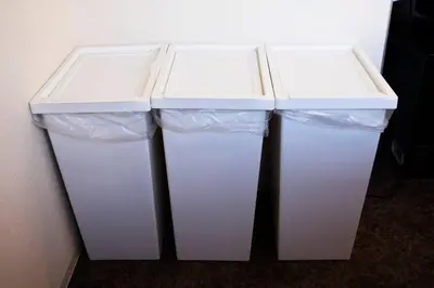 three white trash cans sitting next to a wall at Harebare apartment for max 4ppl 3mins walk from Kiba station 5F in Tokyo