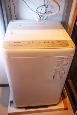 a washing machine sitting on a shelf in a room at Harebare apartment for max 4ppl 3mins walk from Kiba station 5F in Tokyo