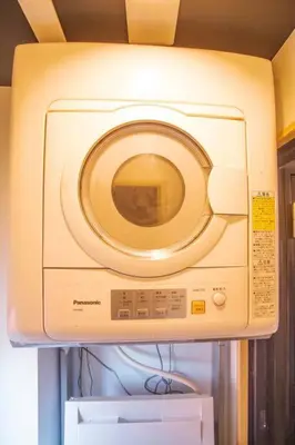 a washing machine sitting on top of a refrigerator at Harebare apartment for max 4ppl 3mins walk from Kiba station 5F in Tokyo