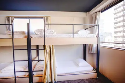 two bunk beds in a room with a window at Harebare apartment for max 4ppl 3mins walk from Kiba station 5F in Tokyo
