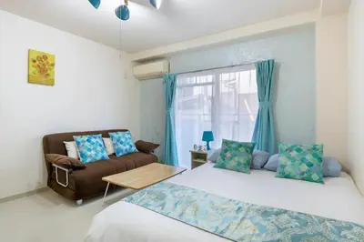 a room with two beds and a couch and a window at #3 -\u30a8\u30af\u30bb\u30eb\u6a4b\u7acb101- Entire Unit in Tokyo