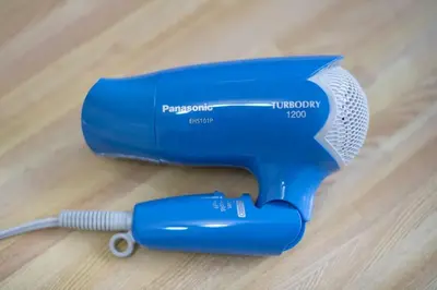a blue hair dryer sitting on top of a wooden floor at #3 -\u30a8\u30af\u30bb\u30eb\u6a4b\u7acb101- Entire Unit in Tokyo