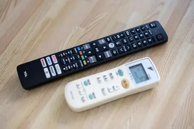 two remote controls sitting on top of a wooden table at #3 -\u30a8\u30af\u30bb\u30eb\u6a4b\u7acb101- Entire Unit in Tokyo