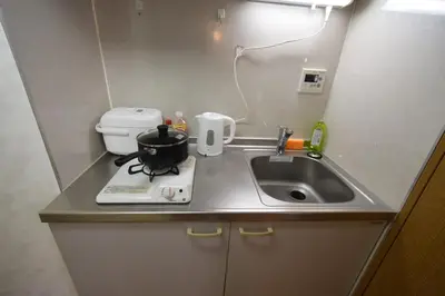 a small kitchen with a sink and a toilet at \u6587\u4eac\u533a\u8c4a\u5cf6\u533a\u5357\u5927\u585a in Tokyo