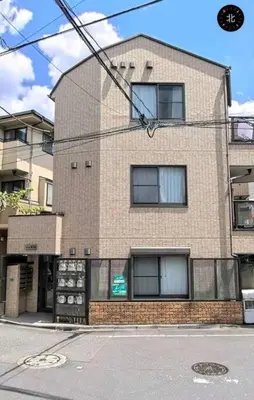 a tall brick building with windows on a street at \u6587\u4eac\u533a\u8c4a\u5cf6\u533a\u5357\u5927\u585a1 in Tokyo