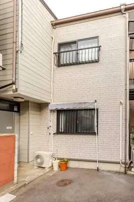 a building with a window and a air conditioner at kensui house in Tokyo