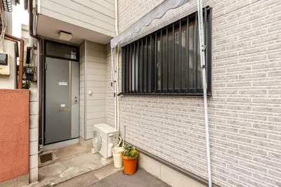 a brick house with a door and a window at kensui house in Tokyo