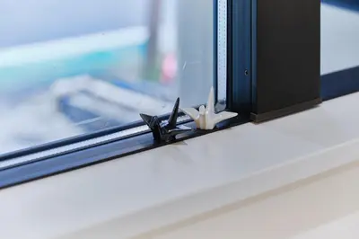 a window with a pair of scissors on a window sill at Kaikai House - Art, Design & Family in Shibuya in Tokyo