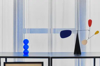 a table with a lamp and a vase on it at Kaikai House - Art, Design & Family in Shibuya in Tokyo