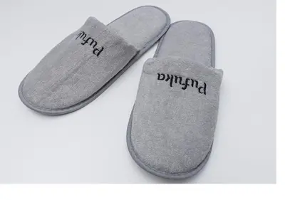 two pairs of gray slippers with the word painful written on them at \u3077\u3075\u304bTK\u6771\u5411\u5cf61F -1min to Higashi Mukojima Sta 1F Cozy Stay Near Skytree Asakusa in Tokyo