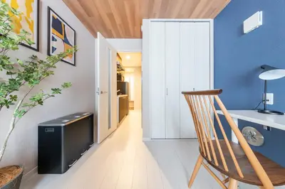 a room with a chair and a desk and a door at \u3077\u3075\u304bTK\u6771\u5411\u5cf61F -1min to Higashi Mukojima Sta 1F Cozy Stay Near Skytree Asakusa in Tokyo