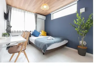 a bedroom with a bed and a desk and a window at \u3077\u3075\u304bTK\u6771\u5411\u5cf61F -1min to Higashi Mukojima Sta 1F Cozy Stay Near Skytree Asakusa in Tokyo