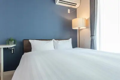 a bedroom with a white bed and a window at \u3077\u3075\u304bTK\u6771\u5411\u5cf61F -1min to Higashi Mukojima Sta 1F Cozy Stay Near Skytree Asakusa in Tokyo