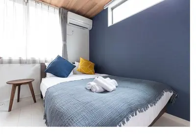 a bedroom with a bed with towels on it at \u3077\u3075\u304bTK\u6771\u5411\u5cf61F -1min to Higashi Mukojima Sta 1F Cozy Stay Near Skytree Asakusa in Tokyo