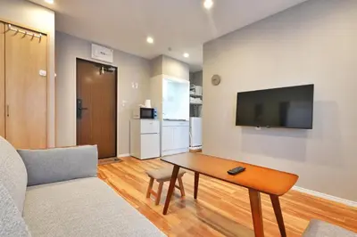 a living room with a table and a tv on a wall at ZJ201 Hanama201 The Skytree Residence A Newly Home by Tokyo Iconic Landmarks in Tokyo