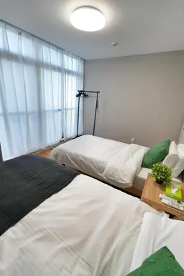 a bedroom with two beds and a window at ZJ201 Hanama201 The Skytree Residence A Newly Home by Tokyo Iconic Landmarks in Tokyo