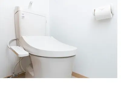 a white toilet in a bathroom with a roll of toilet paper at \u3077\u3075\u304bTK\u6771\u5411\u5cf62F - 1min to Higashi Mukojima Sta 2F Cozy Stay Near Skytree Asakusa in Tokyo